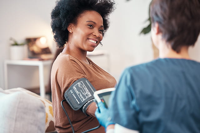 A provider takes a patient's blood pressure