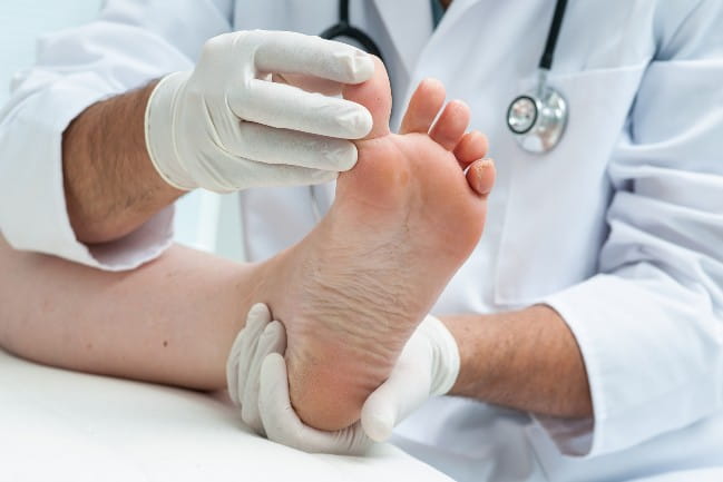 Podiatrist examining a foot
