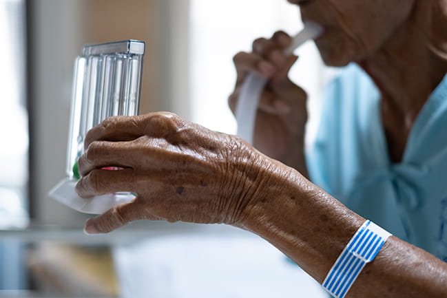 Patient performing pulmonary test by blowing into tube