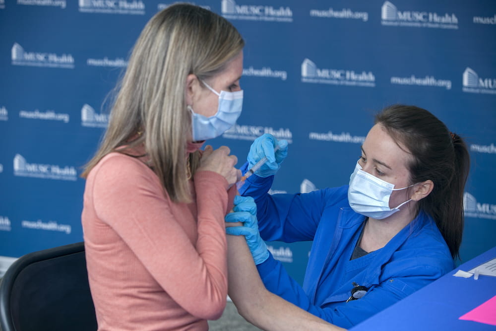 Dr. Danielle Scheurer practices what she preaches, gets the first Pfizer vaccine dose on day one of the rollout.