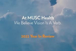Clouds with the words "At MUSC Health We Believe Vision is a Verb. 2022 Year in Review" superimposed.