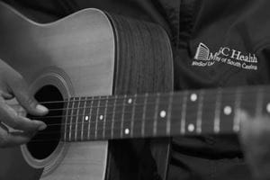 Close-up image of someone playing the guitar