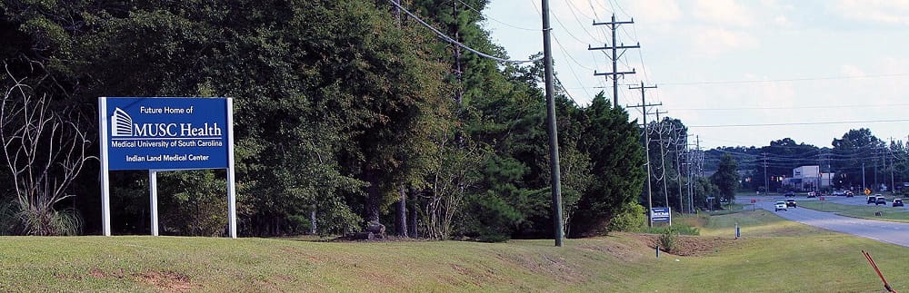 Image of stretch of road with sign that reads: Future Home of MUSC Health Indian Land Medical Center