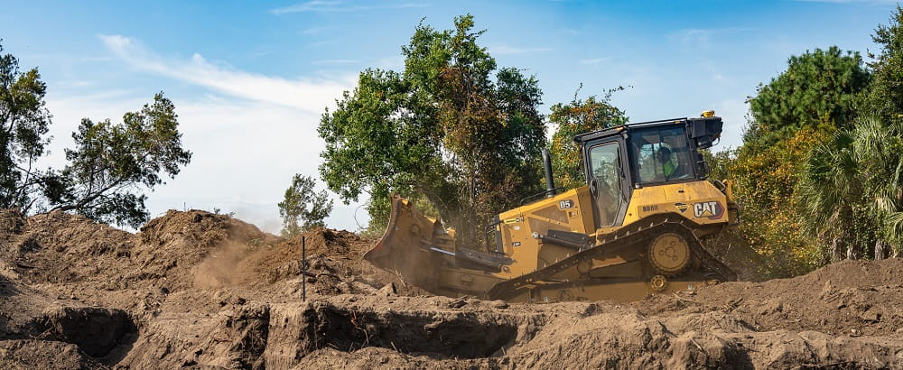 Bulldozer moving earth at the Kiawah Partners Pavilion groundbreaking event.