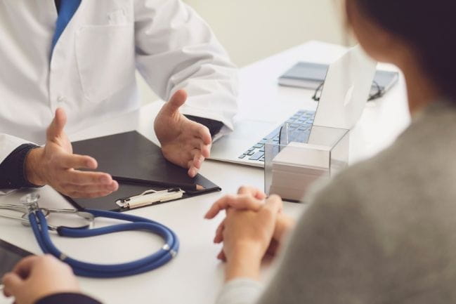 photo of a doctor explaining something to a person