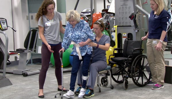 Patient and therapists in clinic