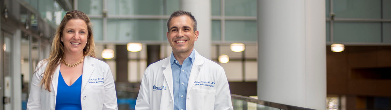 Care team members looking walking in a building and smiling
