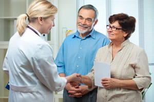 Doctor talking to a couple. 