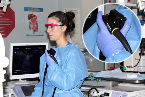 Physician holding an endoscope during an EUS procedure.
