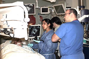 G. I. Fellow observing physician demonstrating an EUS procedure. 
