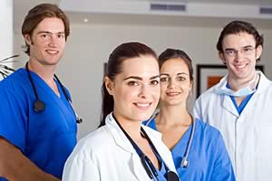 Image of four physicians smiling at the camera.