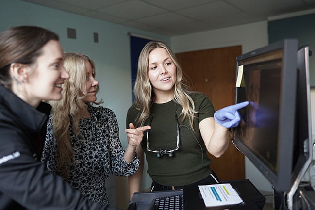 Facial plastic and reconstruction providers review patient data on a computer