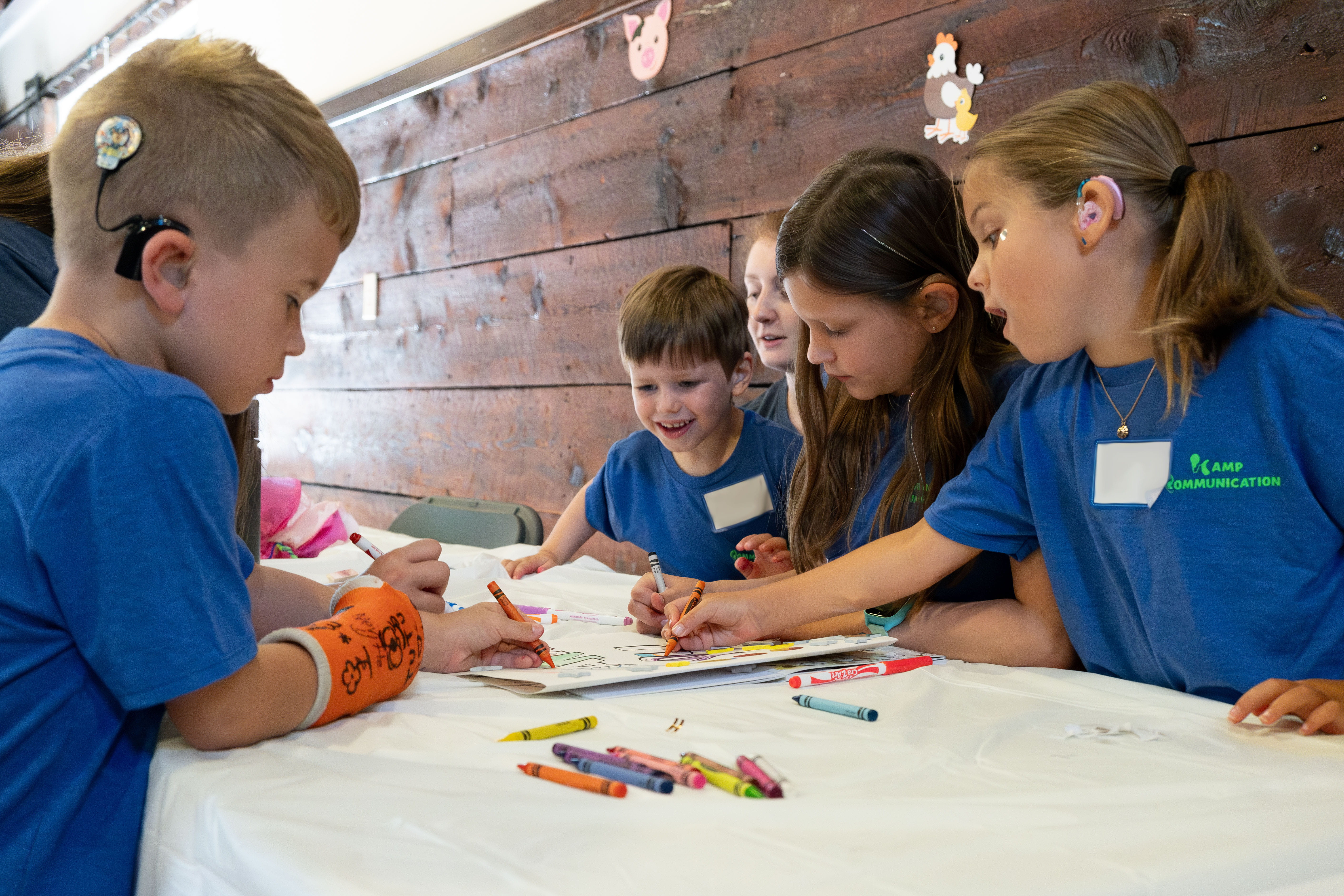 Children with cochlear implants around a. table coloring pictures 