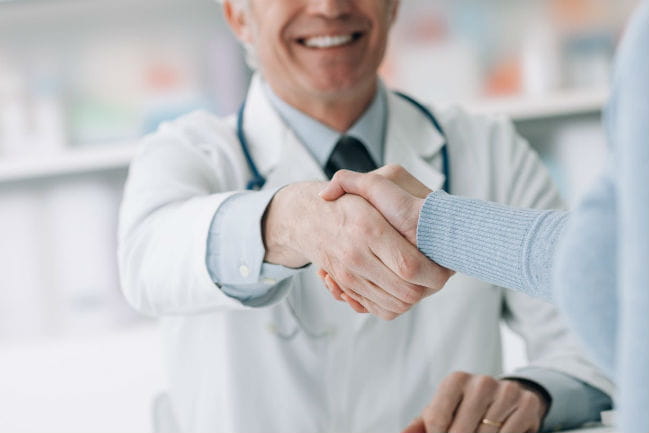 caregiver shaking patient's hand