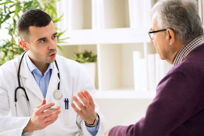 Image of patient and caregiver having conversation.
