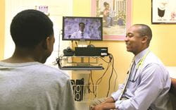 Dr. James Simmons of All Children's Pediatrics demonstrates the technology used for telemental health sessions.
