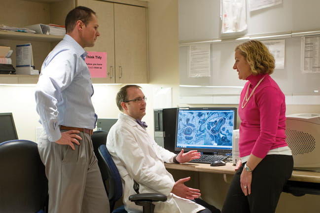 Dr. Lewis Cooper discusses a case with Dr. Jennifer Young Pierce and physics team member Christopher Mart.