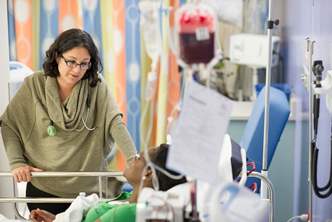 Julie Kanter, M.D., listens to a patient in MUSC’s nationally-ranked hospital.