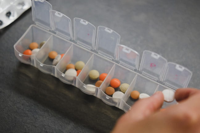 A pill organizer is pictured with pills measured for the week. 