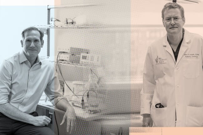 Denis Guttridge sits at a lab bench and John Costello stands at a hospital bedside. 