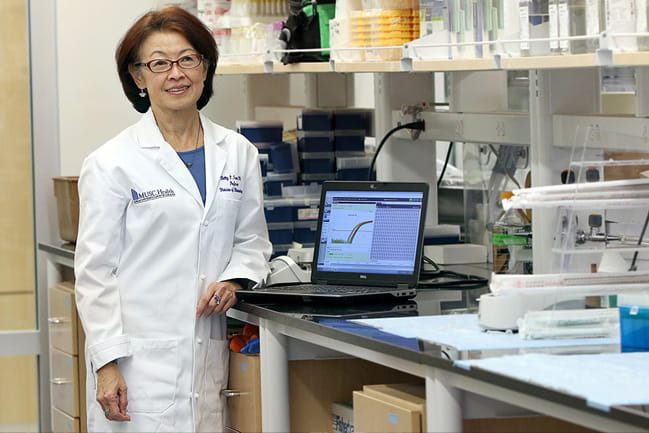 Dr. Betty Tsao stands in her lab.