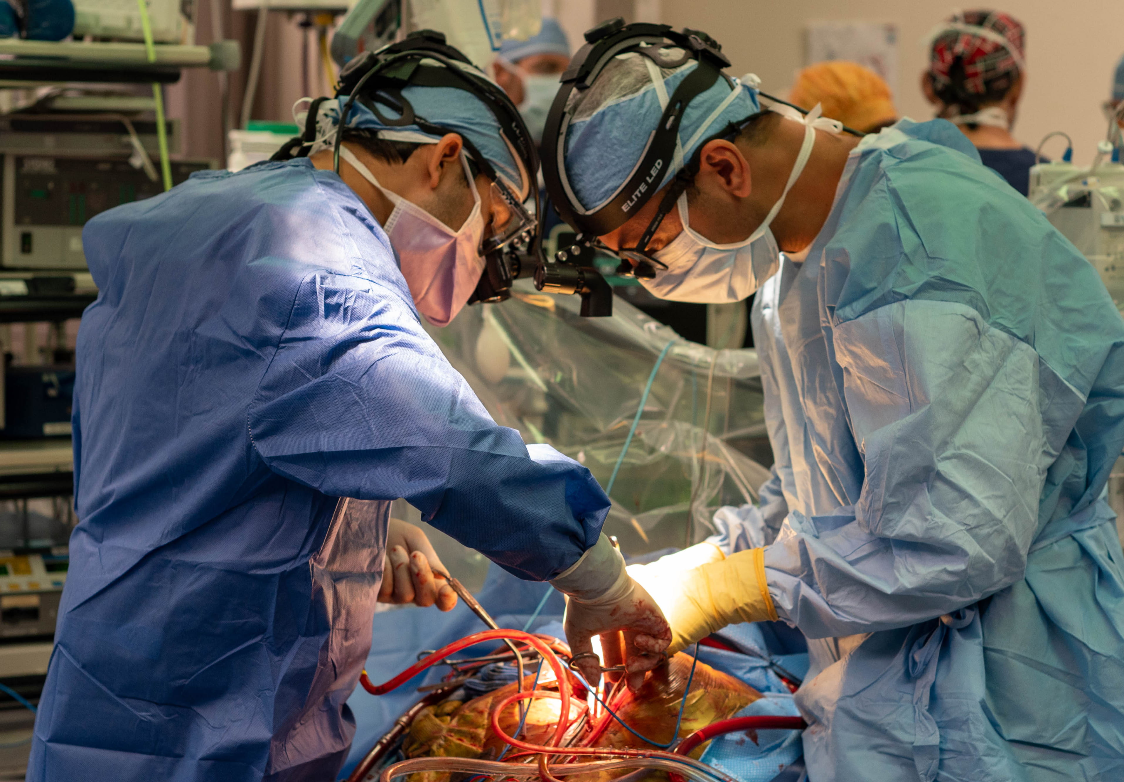 Two surgeons performing open-heart transplant surgery