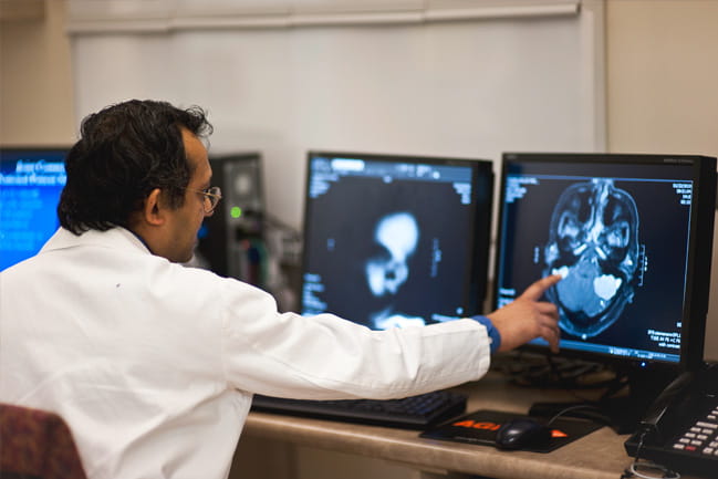 Sunil Patel, M.D., looks at a scan of the brain. 