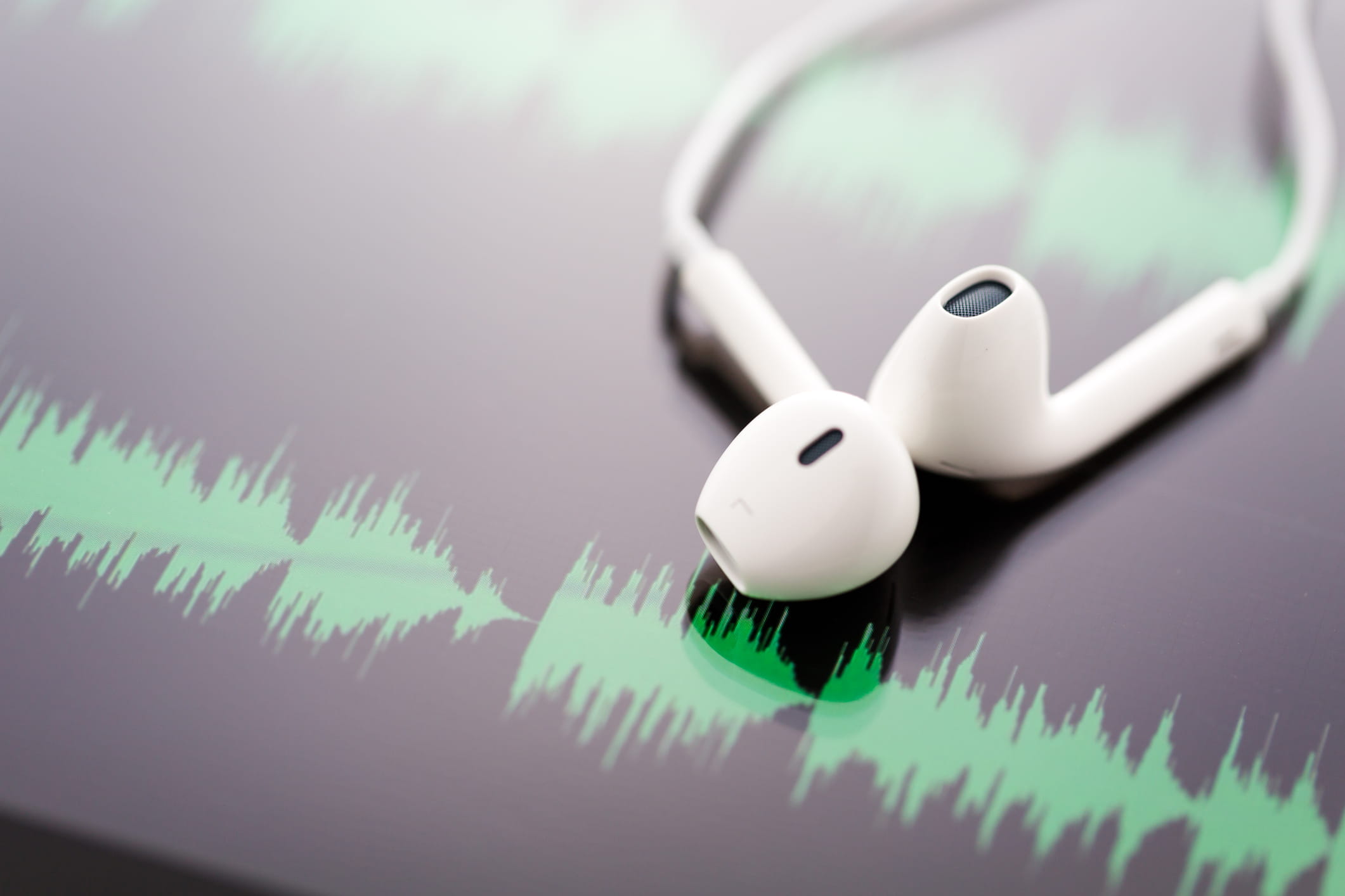 Earbuds over audio file image to represent a podcast
