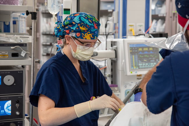 Natalie Barnett, M.D., performing an epidural on a patient in the OR