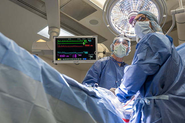 Surgeon and physician assistant working on a patient in the operating room