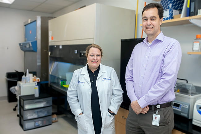 Lauren Ball, Ph.D., (left), director of the Mass Spectrometry Facility at the MUSC Proteomics Center, and Eric Meissner, M.D., Ph.D., (right), an associate professor in the Division of Infectious Diseases at MUSC, are co-authors of the Journal of Viral Hepatitis article.