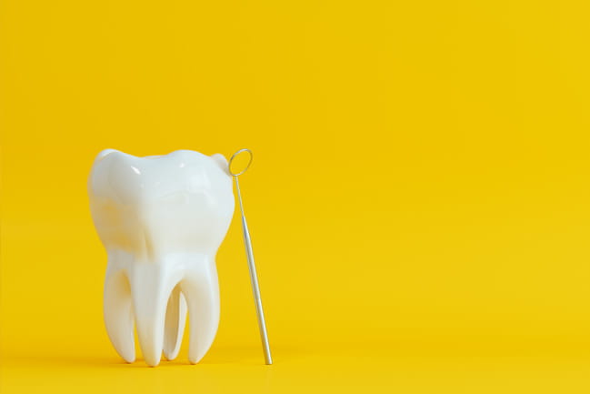 a tooth over a yellow background