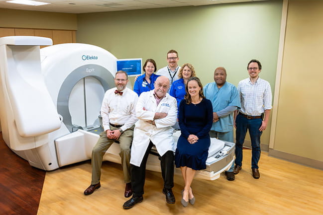 The Gamma Knife team includes, sitting from left, Samuel Cooper, M.D., Istvan Takacs, M.D., and Charlotte Rivers, M.D., as well as highly trained nurses and technicians. Credit: Clif Rhodes