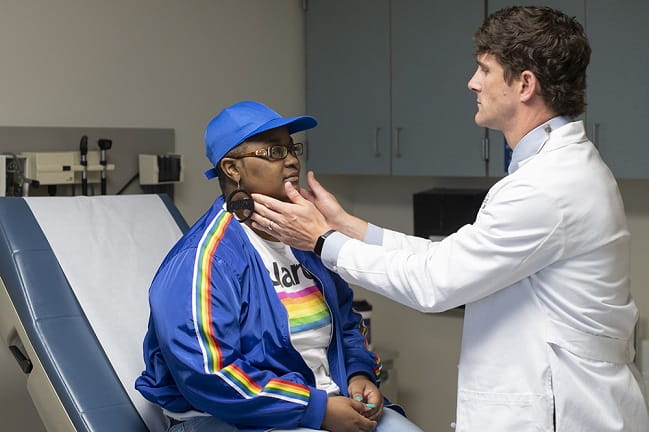 Dr. Ennis James with a patient