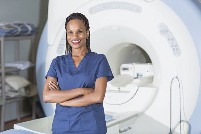 woman in scrubs with MRI machine
