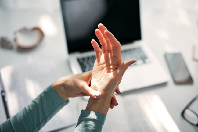 Person massaging wrist