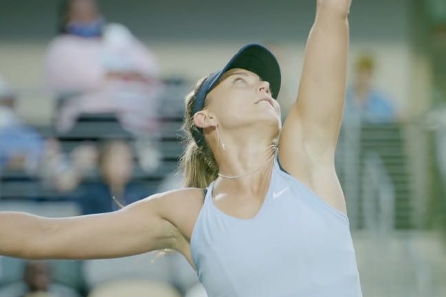 Close up of tennis player serving.