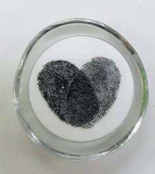 Fingerprints in shape of heart in glass