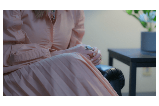 Close-up view of someone sitting.