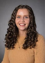 Portrait photo of a lady in yellow sweater