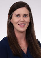 Photo of Sarah Bourne in blue tshirt on a white background