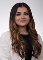 Photo of Tirza Alcala in off-white cardigan on a white background