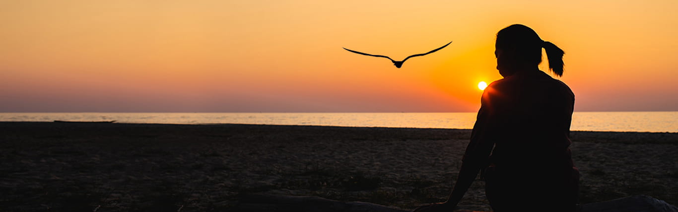 A woman looks out on the horizon with hope. 