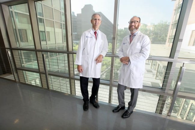 Two doctors standing next to one another smiling at the camera. (Left to right: Charles Reitman, M.D., and Bruce Frankel, M.D.)