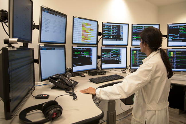 Photo of doctor viewing ICU monitors