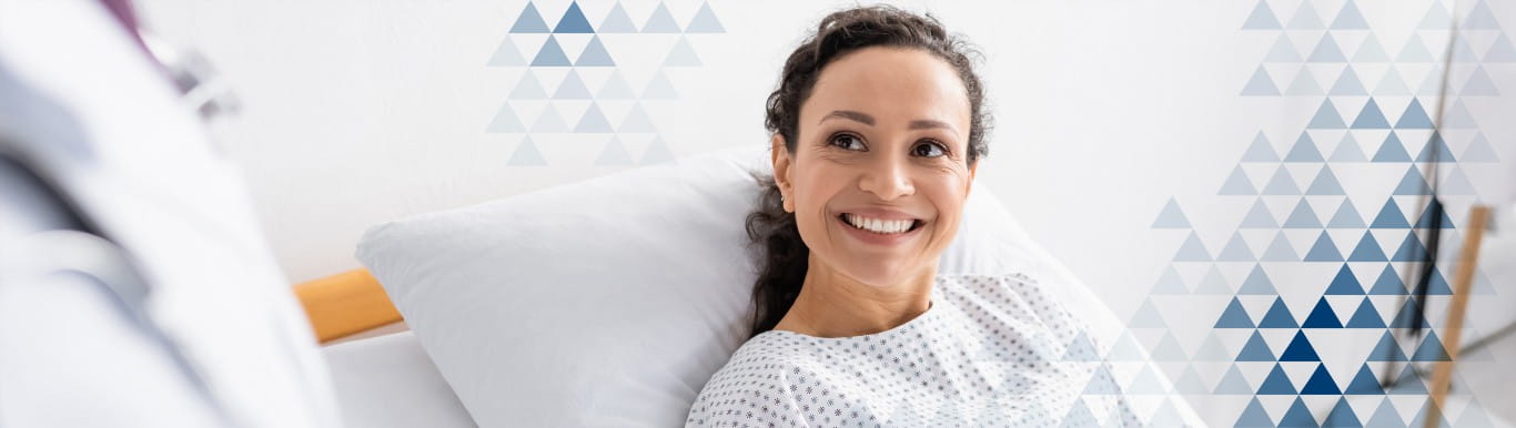 Smiling woman in bed.