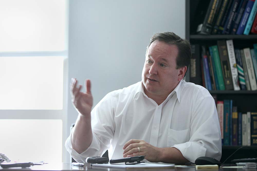 Dr. Graham Warren at his desk