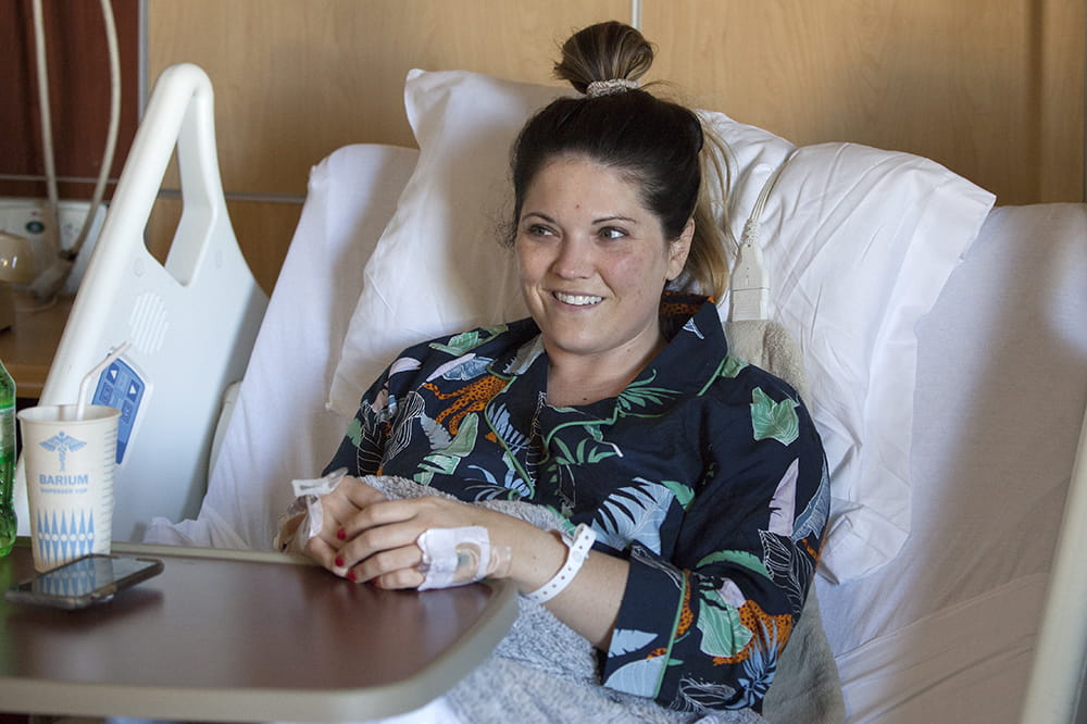 Laura Hoover smiles in her hospital bed