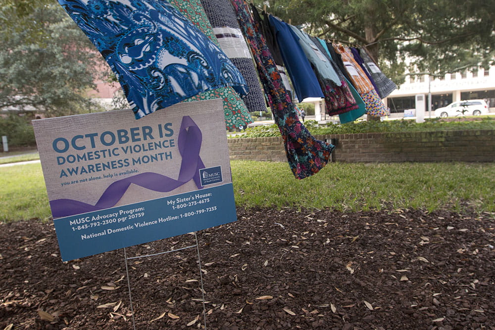 A sign notes that October is domestic violence awareness month.