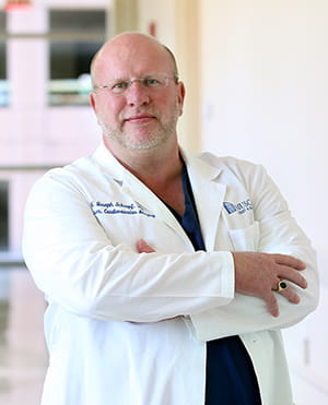 profile picture of Dr. Schoepf in white coat in hallway